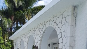A multi-level building with a white exterior and a cracked stone pattern. - 5 Bed Room Villa with Swimming pool  (Montego Bay)