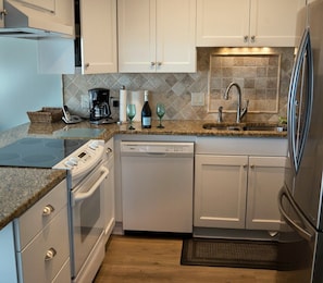 Enjoy cooking in this well-equipped kitchen with an oven, dishwasher, and refrigerator.