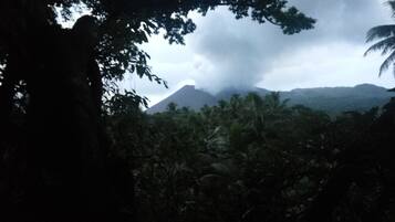 A view of a mountain with a cloudy sky.
