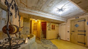A rustic interior with a stone fireplace, wooden doors, and a spiral staircase leading to another room. - Perla Ski in, Livigno, Italy (Livigno)