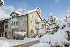 A multi-story building with balconies and a snow-covered landscape. - Perla Ski in, Livigno, Italy (Livigno)