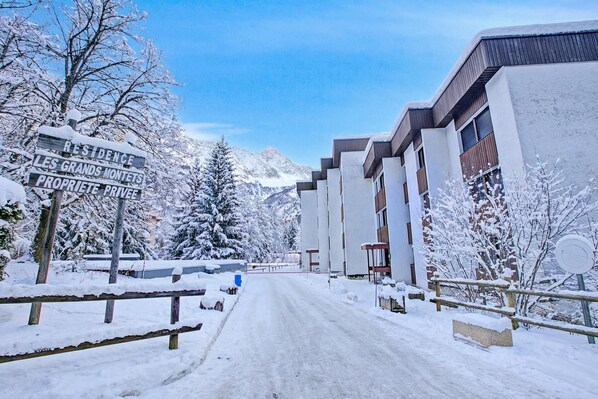 A snow-covered street with a sign indicating a private property.