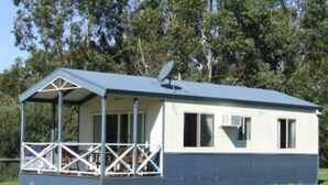 A small, single-story building with a covered porch and a satellite dish. - Discovery Parks - Kangaroo Island (Karatta)