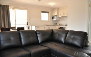 Deluxe 2 Bedroom Cabin - Sleeps 4 | Living area | Flat-screen TV