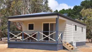 A single-story mobile home with a covered porch and a ramp leading to the entrance. - Discovery Parks - Kangaroo Island (Karatta)