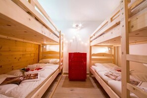 A room with bunk beds, a red dresser, and a ceiling light fixture. - Grand Roc C306 280m from Slopes, View, Parking & WiFi, Argentière (Chamonix), France (Argentière (Chamonix))