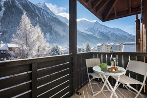 A balcony with a view of snow-covered mountains and a town below. - Cham Sud Grepon Paradis611 Mont Blanc View Studio, Walk to Centre, Chamonix, France (Chamonix)