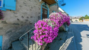 A building with a stone facade, a wooden balcony, and a metal railing. - Diamante Ski in, Livigno, Italy (Livigno)