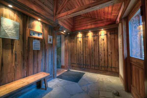 A wooden interior with a bench, stone floor, and wooden lockers. - Apt Bellachat10 for 4 w/ pool & 120m to lift, Les Houches (Chamonix), France (Les Houches (Chamonix))
