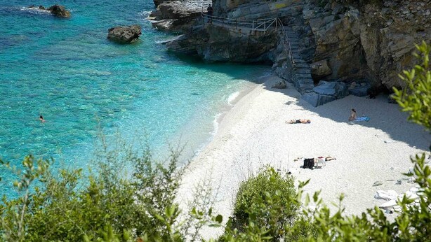 A beach with clear turquoise water, white sand, and rocky cliffs. - PELION HOMES | STONE HOUSE  charming villa with amazing view for 2-4 guests (Agios Georgios Nilias)