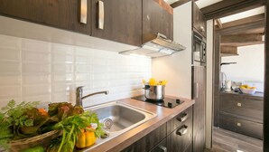 A modern kitchen with a stainless steel sink, wooden cabinets, and a built-in oven. - Grand Roc B309 260m from Slopes, Mont-Blanc View, Parking & WiFi, Argentière (Chamonix), France (Argentière (Chamonix))