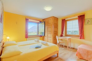 Una habitación con dos camas, un escritorio y una silla.