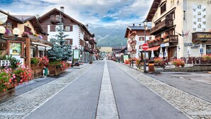 A street lined with traditional buildings, some with balconies, and a clear sky. - Rubino Ski in, Livigno, Italy (Livigno)