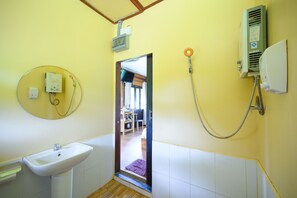 A bathroom with a sink, a shower, and a toilet.
