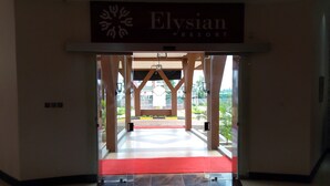 An entrance to Elysian Resort with a red carpet and a sign above. - Elysian Resort (Nairobi)