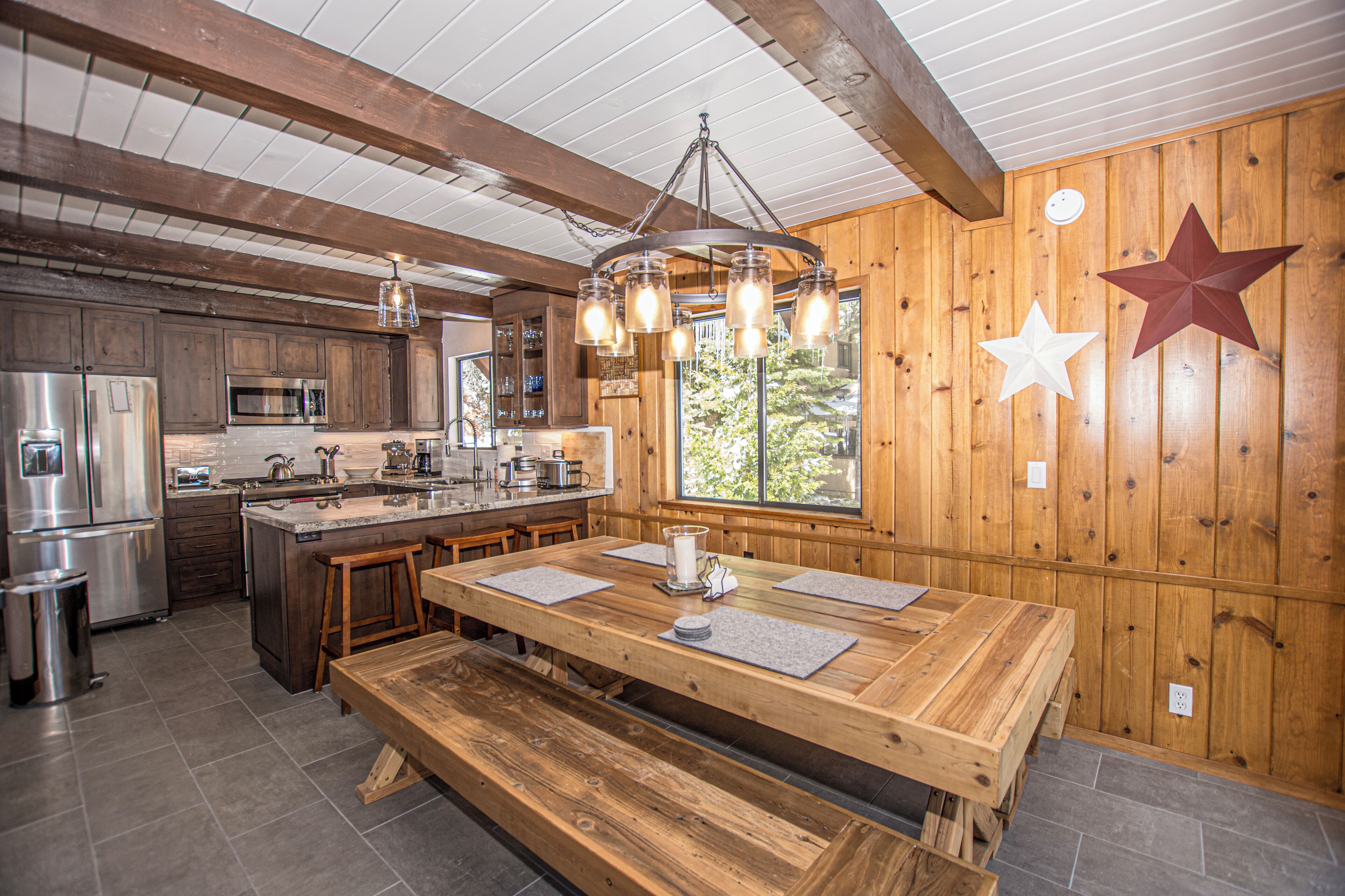 A spacious kitchen with wooden cabinetry, a large island, and modern appliances.