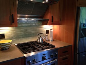 Enjoy cooking in this well-equipped kitchen with a gas stove, oven, and refrigerator.