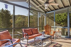Relax in a serene forest setting with a comfortable seating area and unobstructed views.