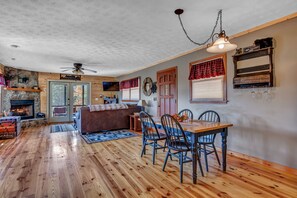 Cozy space with a dining area, fireplace, and comfortable seating.