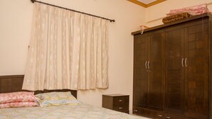 Une chambre à coucher avec un lit, une armoire et une table de chevet.