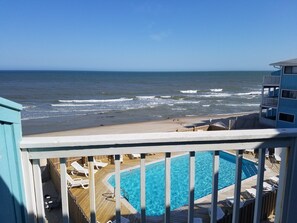 A pool area with a view of the ocean. - Kure Beach Condo Next to Historic Ft. Fisher! (Kure Beach)