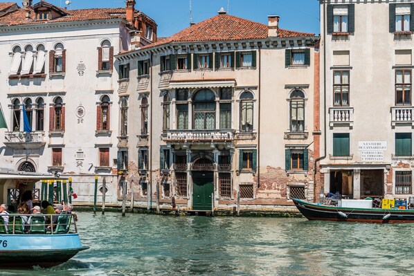 A historic building with a green door and a sign above it. - Admiral Emo Palace Over Canal Grande (Venice)