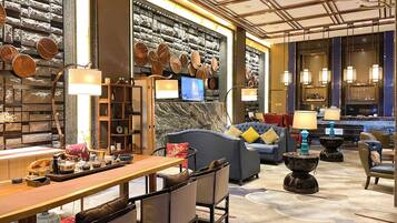 A modern interior with a bar area, seating, and a wall decorated with pottery.
