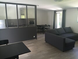 Classic Studio, Garden View | Living area | Flat-screen TV