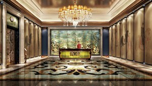 A luxurious lobby with a grand chandelier, a decorative console table, and a large mural on the back wall. - Wanda Vista Nanning (Nanning)