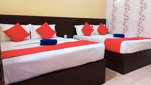 Two double beds with red and white bedding, a wooden headboard, and a floral-patterned wall. - Hotel Bharat Palace (Jaipur)