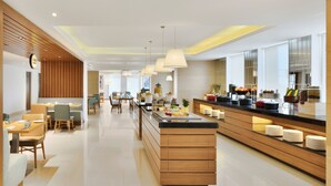 A modern hotel lobby with a central island, seating areas, and a reception desk. - Fairfield by Marriott Chennai OMR (Chennai)
