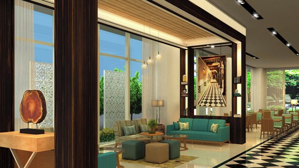 A modern lobby with a checkered floor, a wooden reception desk, a green sofa, and a chandelier. - Fairfield by Marriott Chennai OMR (Chennai)