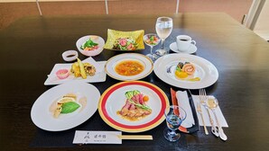 A dining table set with various dishes, including a bowl of soup, a plate of sushi, and a glass of water. - Enmeikan (Asakura)