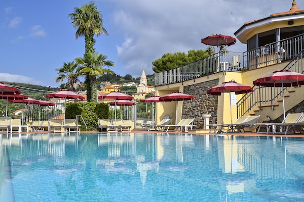 Seasonal outdoor pool, open 9:00 AM to 6:00 PM, pool umbrellas