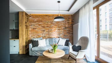 Departamento Premium, 1 habitación | Área de sala de estar | Televisión de pantalla plana