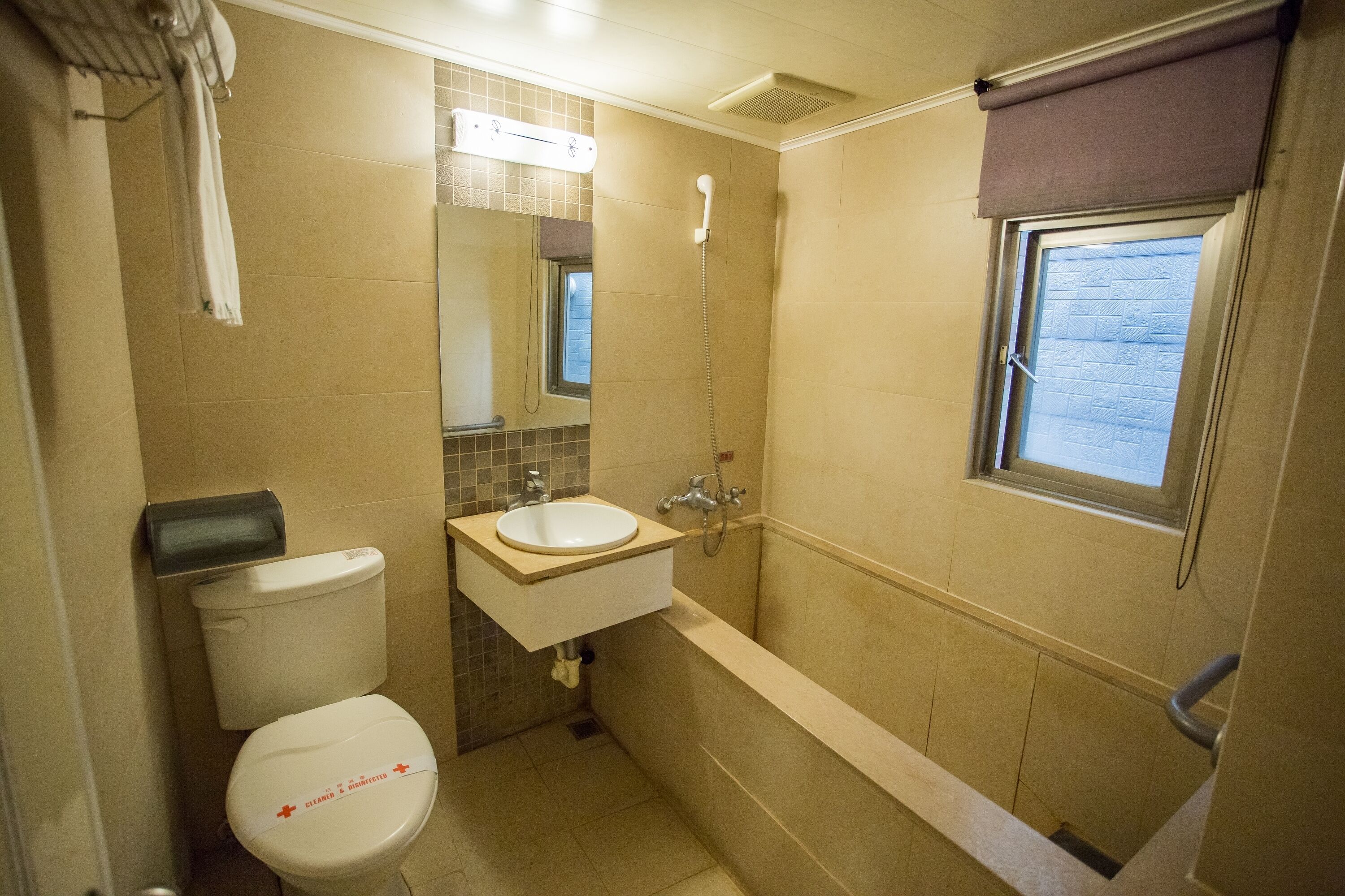 A compact bathroom with a toilet, sink, and bathtub.