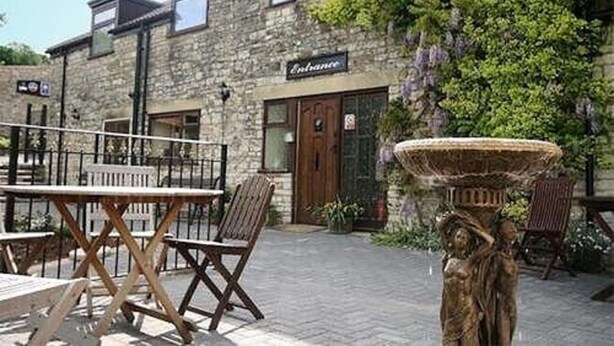 A stone building with a sign reading "Entrance." - The Old Malt House Hotel (Bath)