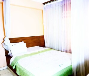 Habitación individual | Escritorio y ropa de cama