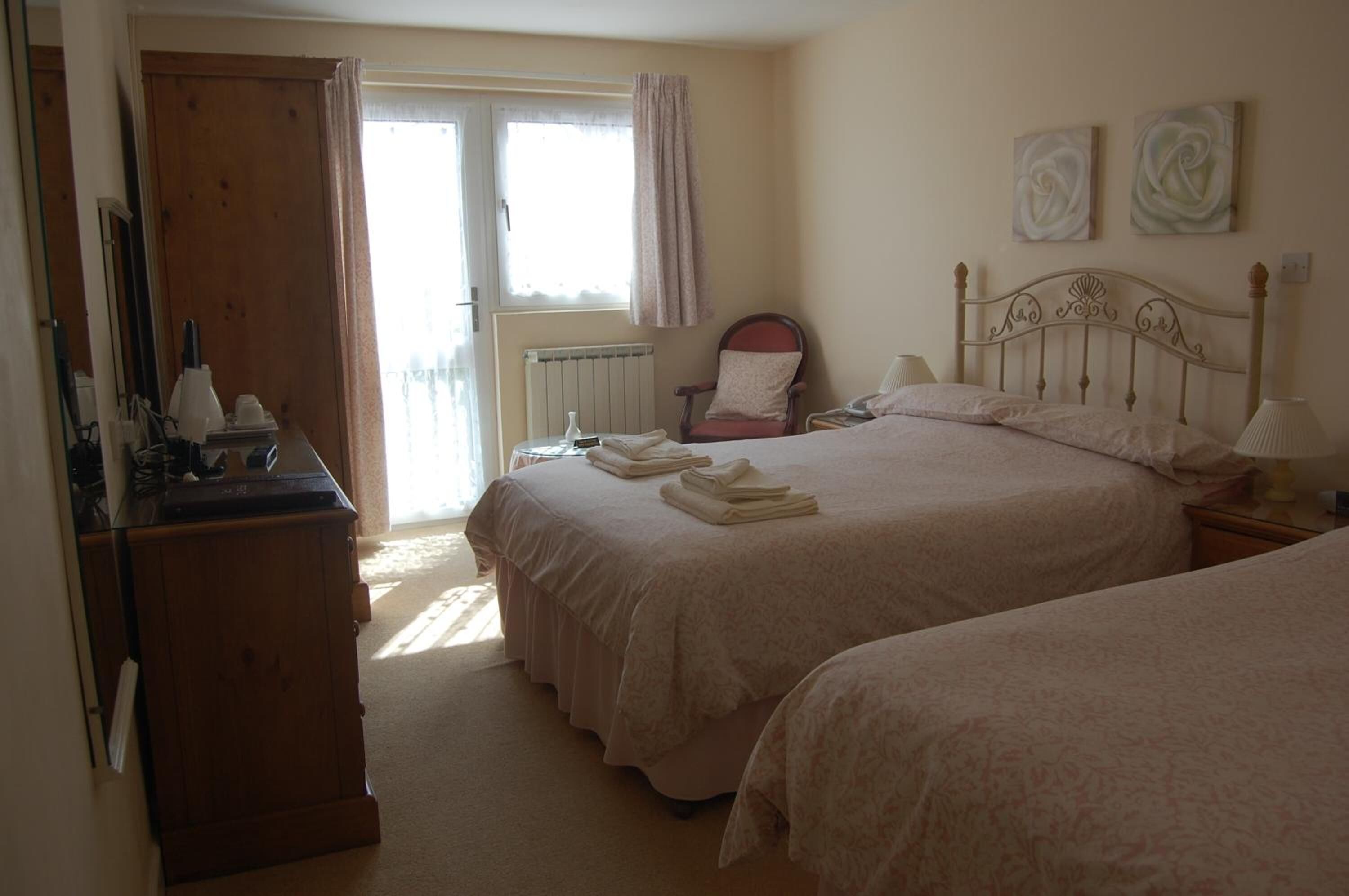 desk, iron/ironing board, bed sheets