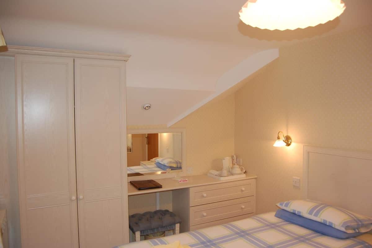 desk, iron/ironing board, bed sheets