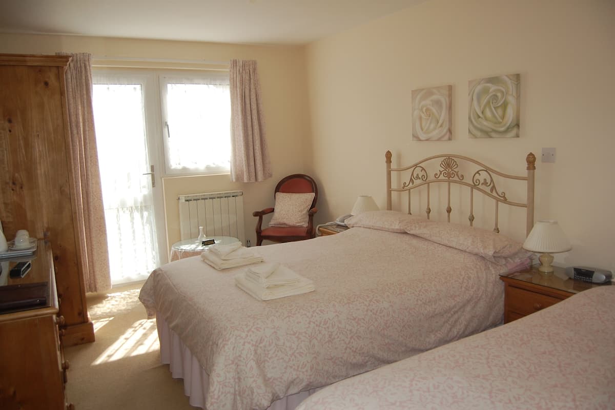 Desk, iron/ironing board, bed sheets