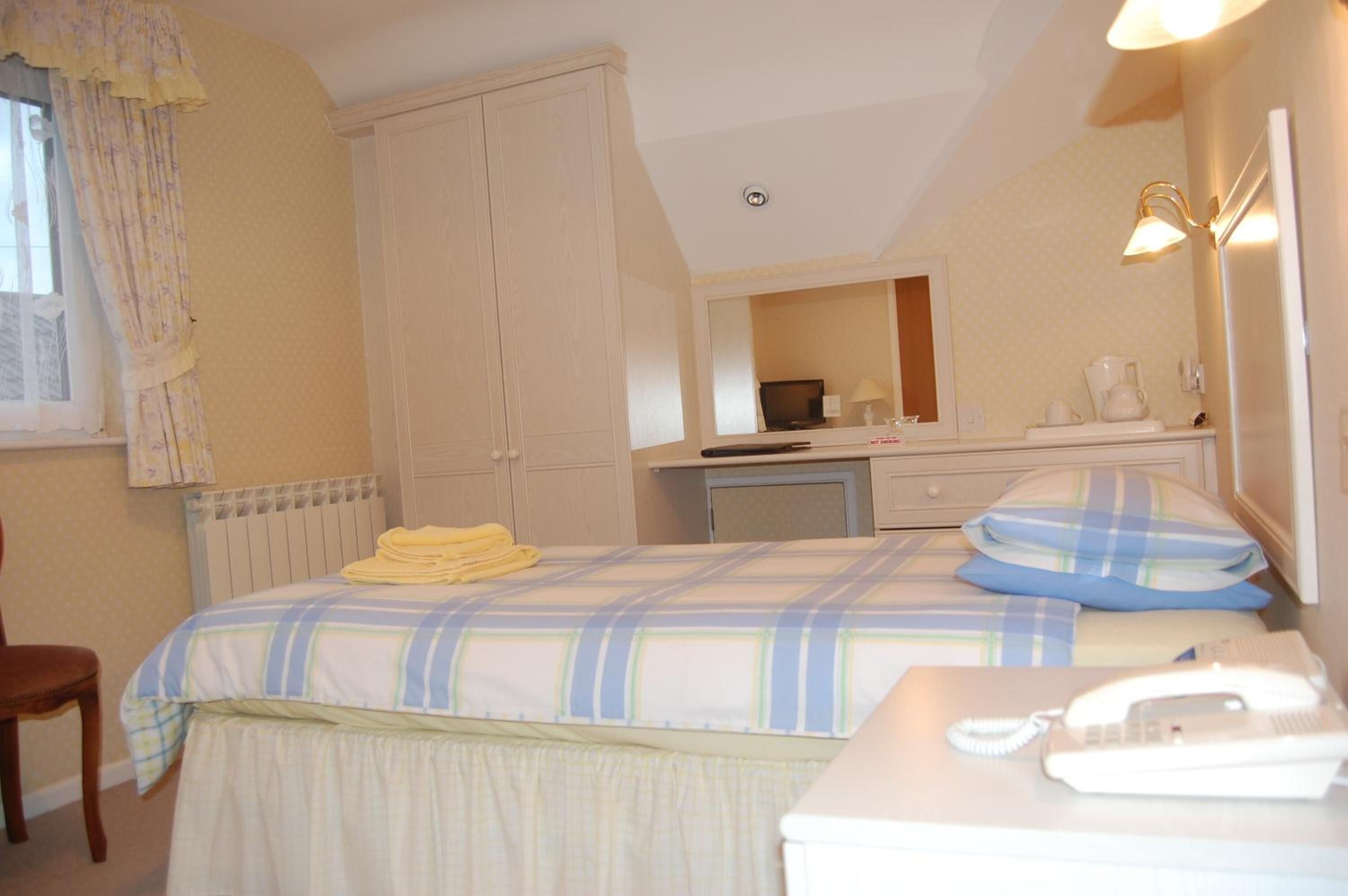 desk, iron/ironing board, bed sheets