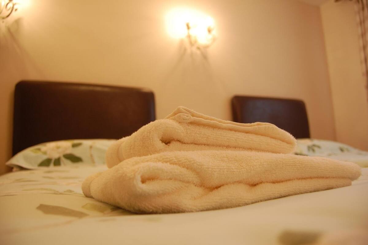 desk, iron/ironing board, bed sheets