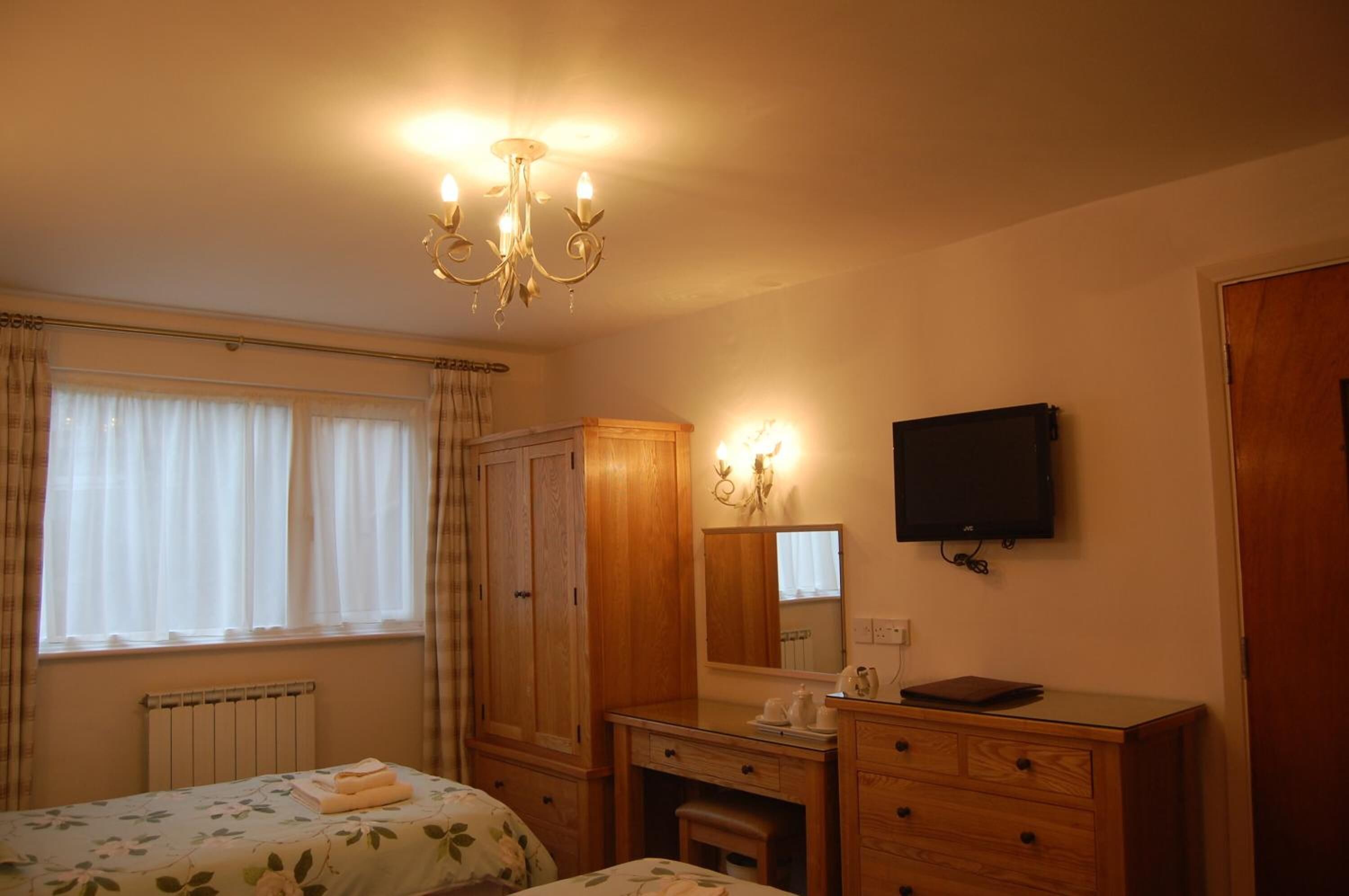 desk, iron/ironing board, bed sheets