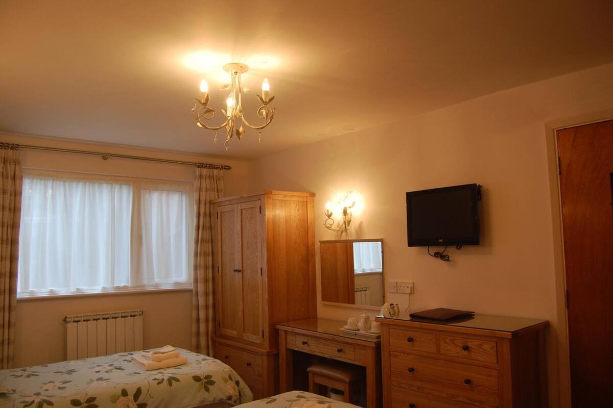 desk, iron/ironing board, bed sheets