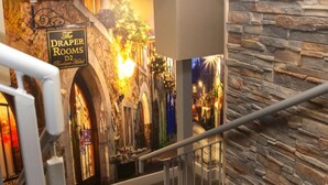A staircase with a stone wall on one side and a sign for 'The Draper Rooms Boutique Hotel' on the other. - Draper Rooms (Dublin)