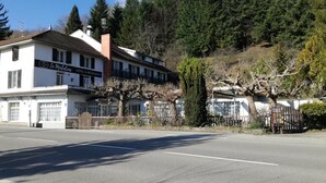 A hotel named "Le Malizia" with a white facade, multiple windows, and a visible entrance. - Le Malatras (Tullins)