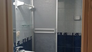 A bathroom with a white sink, a toilet, and a shower area. - Hotel Santa Beatriz (Cusco)