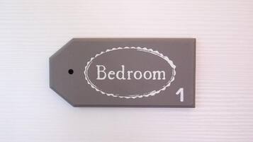 A tag labeled 'Bedroom 1' on a textured surface.