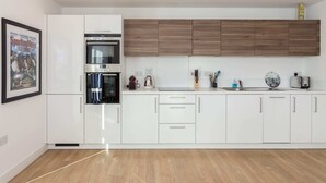 Apartment, 3 Bedrooms | Private kitchen | Coffee/tea maker, full-size fridge, oven, cookware/dishes/utensils